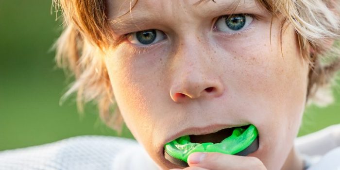 Boy putting in his sports mouth guard