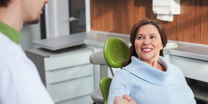 woman discussing deep cleaning with the dentist
