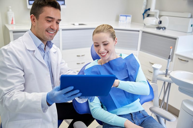 Woman Talking with Dentist